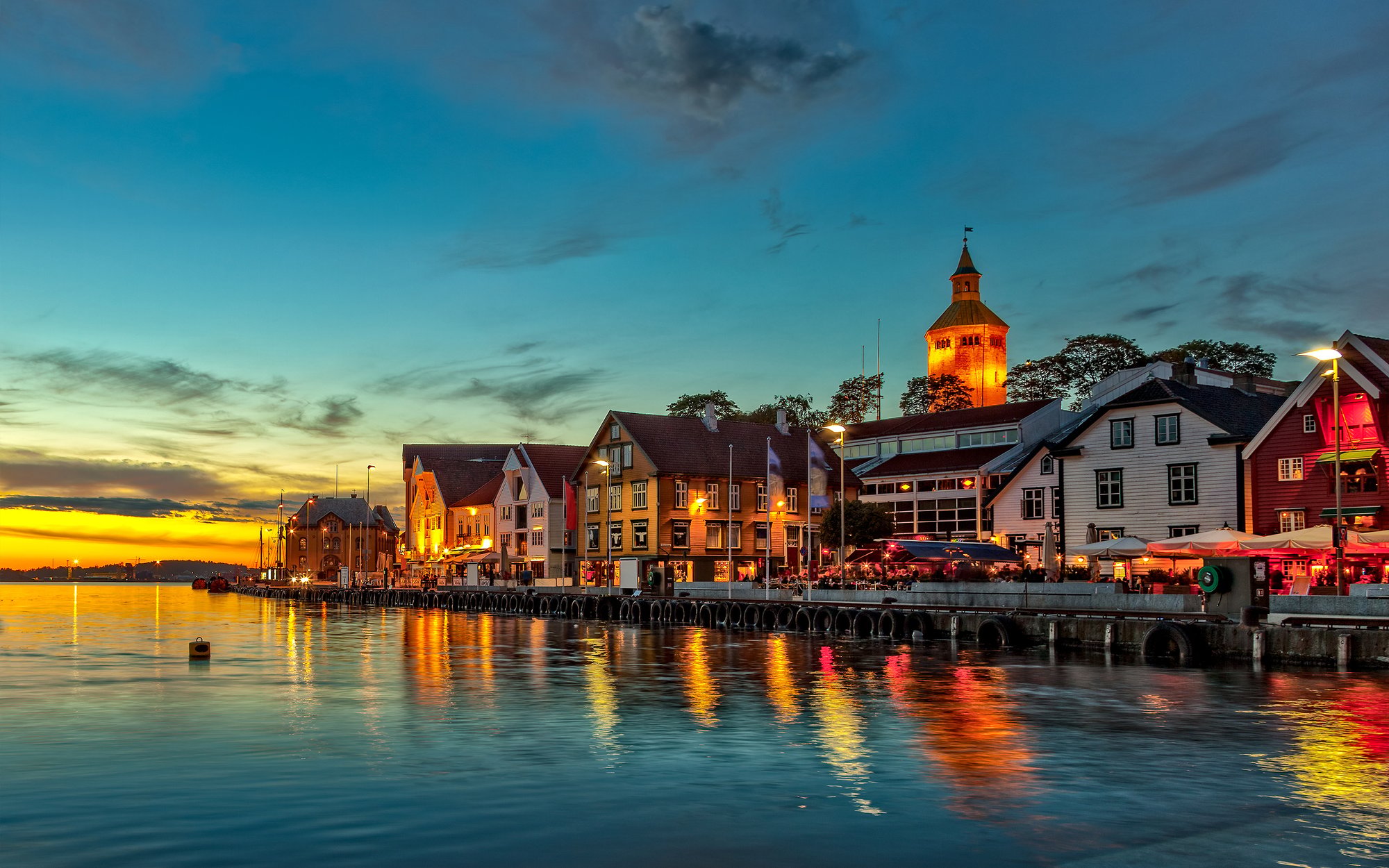Stavanger old harbour lit up at dusk