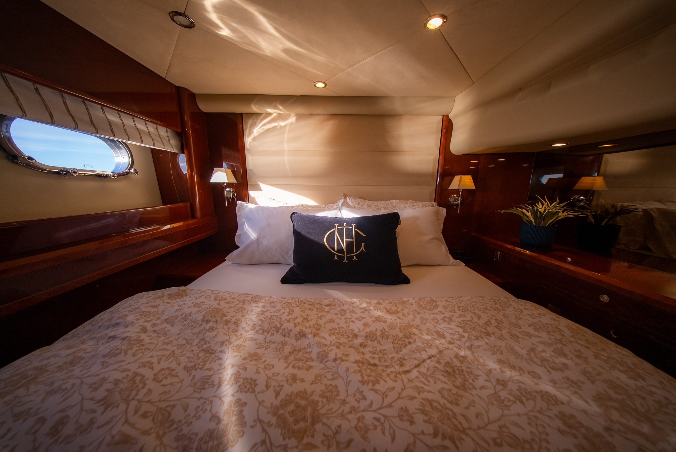 Double cabin aboard Barolo III with portholes and wood panelling