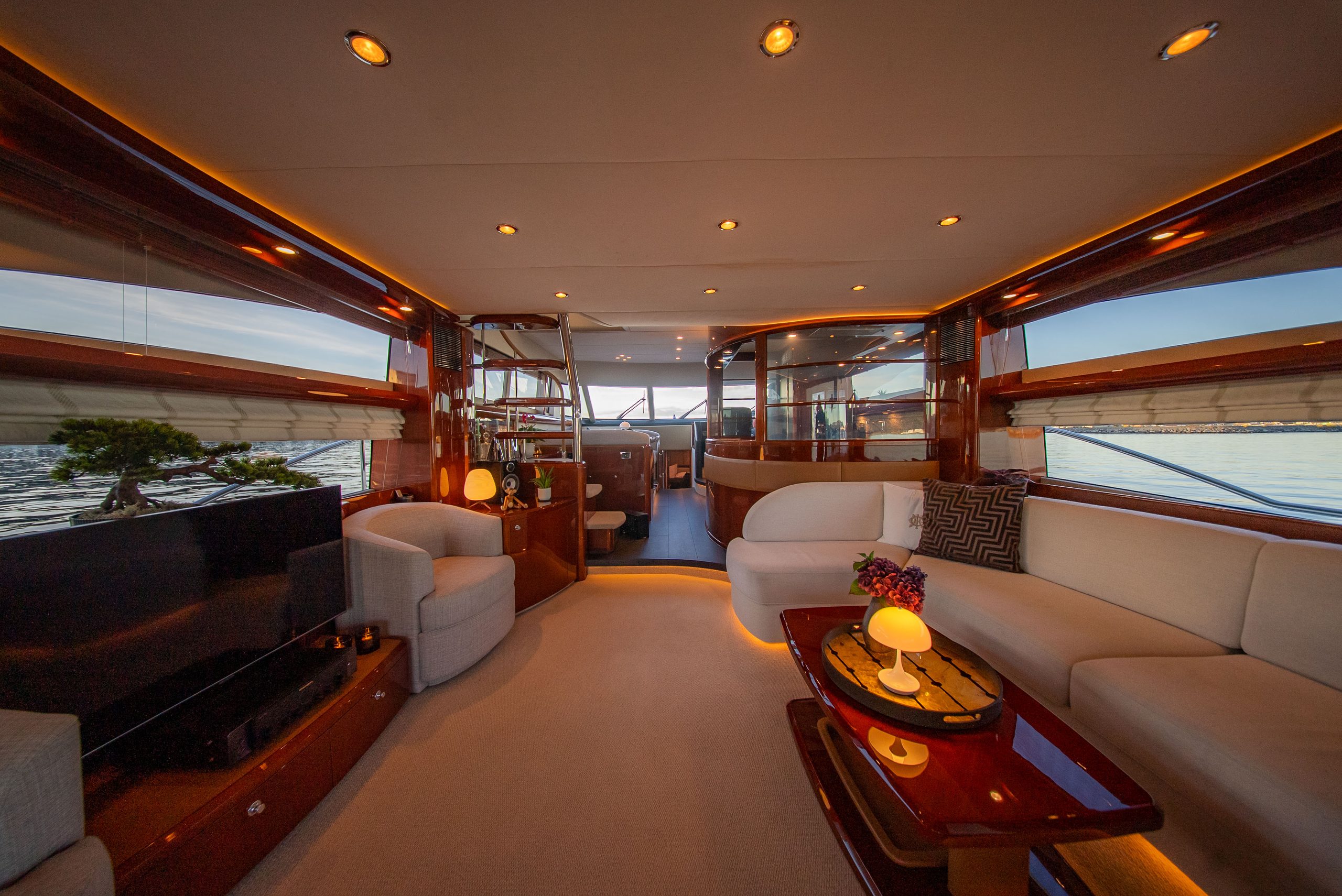 The main salon on Barolo III in the evening, cream sofas and polished wood